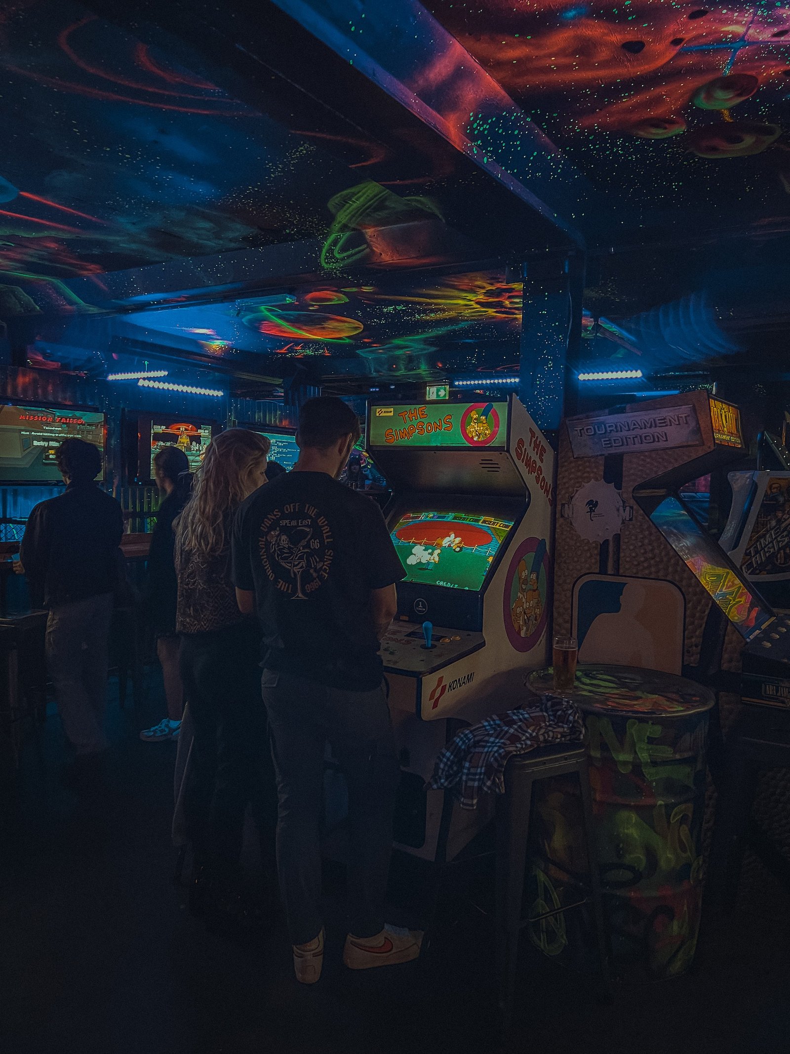 Pixel Pint Patrons Playing Arcade Games